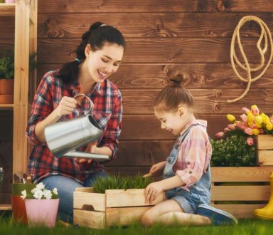 A woman and girl in the grass with boxes.