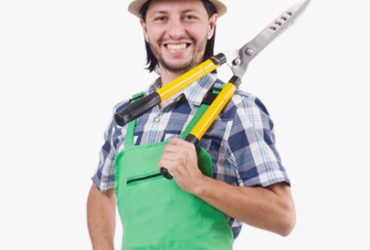 A man holding two pairs of scissors in his hands.