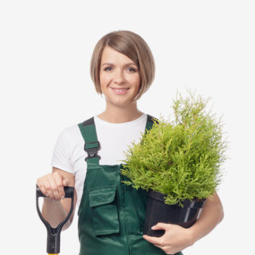 A woman holding a plant and a pair of scissors.