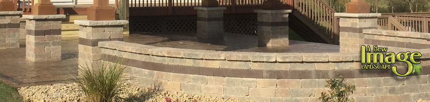 A brick patio with steps and a railing.